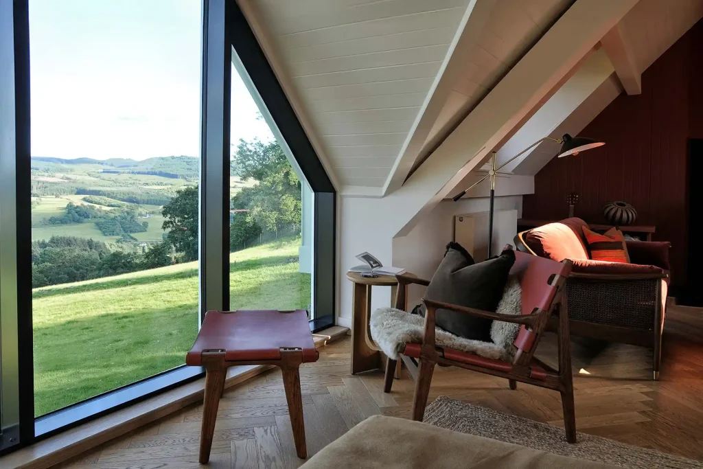 Loft lounge with floor-to-ceiling Highland views at Aodin